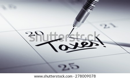 Concept image of a Calendar with a golden dart stick. The words Taxes written on a white notebook to remind you an important appointment.