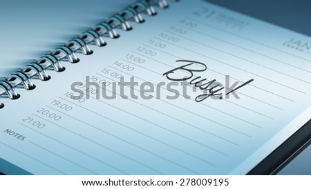Closeup of a personal calendar setting an important date representing a time schedule. The words Busy written on a white notebook to remind you an important appointment.