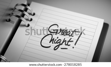 Closeup of a personal agenda setting an important date representing a time schedule. The words Great Night written on a white notebook to remind you an important appointment.