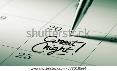 Closeup of a personal agenda setting an important date written with pen. The words Great Night written on a white notebook to remind you an important appointment.