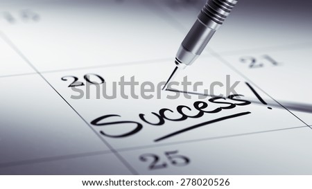 Concept image of a Calendar with a golden dart stick. The words Success written on a white notebook to remind you an important appointment.