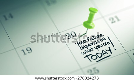 Concept image of a Calendar with a green push pin. Closeup shot of a thumbtack attached. The words Your future depends on what you do today written on a white notebook to remind you an appointment.
