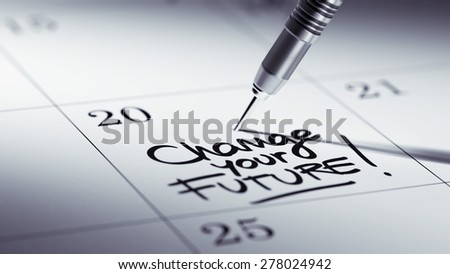 Concept image of a Calendar with a golden dart stick. The words Change your future written on a white notebook to remind you an important appointment.