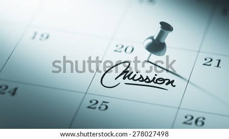 Concept image of a Calendar with a push pin. Closeup shot of a thumbtack attached. The words Mission written on a white notebook to remind you an important appointment.
