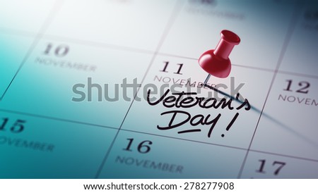 Concept image of a Calendar with a red push pin. Closeup shot of a thumbtack attached. The words Veteran\'s Day written on a white notebook to remind you an important appointment.