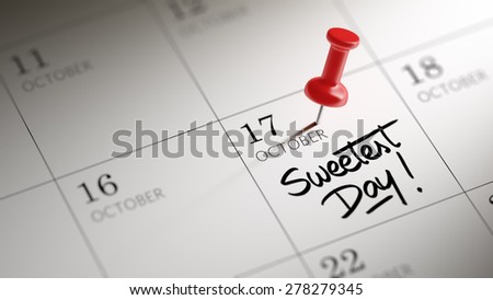 Concept image of a Calendar with a red push pin. Closeup shot of a thumbtack attached. The words Sweetest Day written on a white notebook to remind you an important appointment.