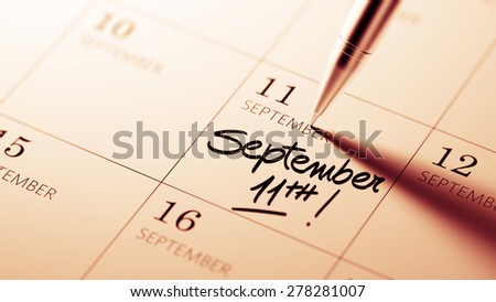 Closeup of a personal agenda setting an important date written with pen. The words September 11th written on a white notebook to remind you an important appointment.