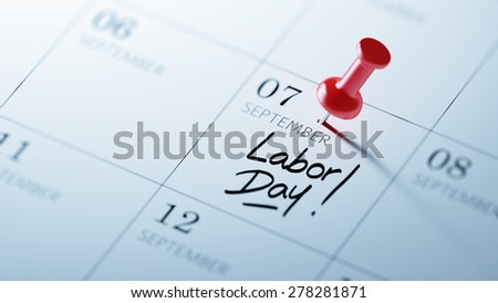 Concept image of a Calendar with a red push pin. Closeup shot of a thumbtack attached. The words Labor Day written on a white notebook to remind you an important appointment.