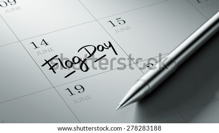 Closeup of a personal agenda setting an important date written with pen. The words Flag Day written on a white notebook to remind you an important appointment.