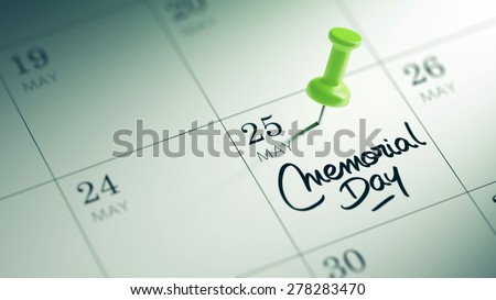 Concept image of a Calendar with a green push pin. Closeup shot of a thumbtack attached. The words Memorial Day written on a white notebook to remind you an important appointment.