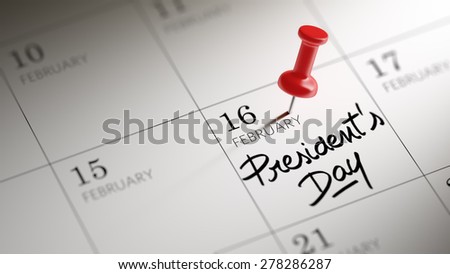 Concept image of a Calendar with a red push pin. Closeup shot of a thumbtack attached. The words President\'s Day written on a white notebook to remind you an important appointment.