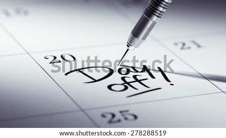 Concept image of a Calendar with a golden dart stick. The words Day off written on a white notebook to remind you an important appointment.