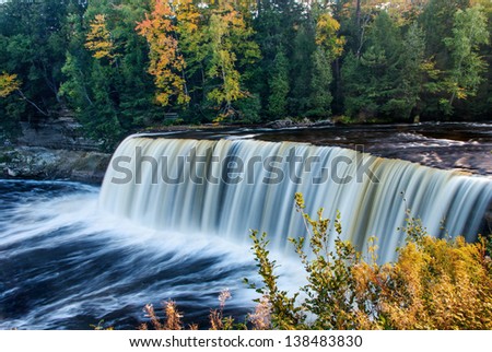Fall colors enhance the view of Tahquamenon Falls.