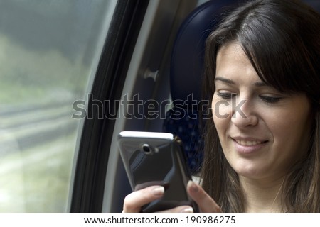 using smart phone in train by window