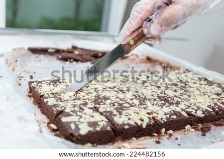 Cutting a cake into slices. Making Chocolate Brownie