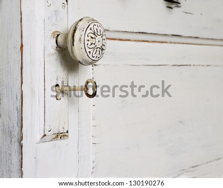 An Old Fashioned Door with a knob and Skeleton Key