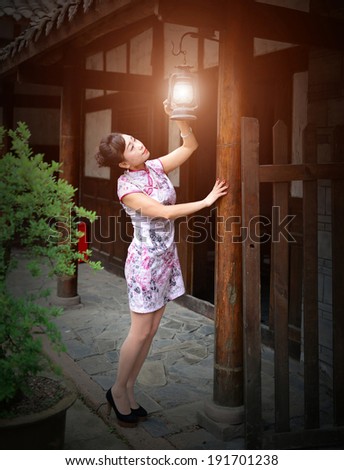 An old courtyard house in China, a woman lit a lamp