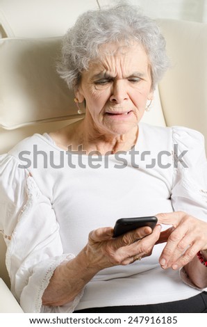 old woman angry about message on smart phone