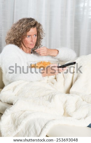 woman eating chips and zapping