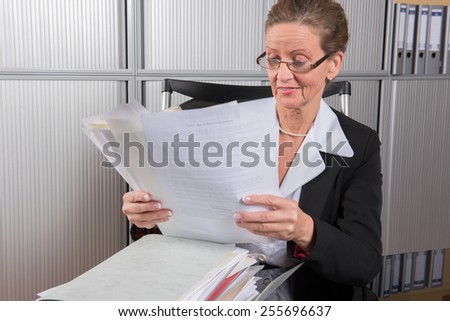 female chef in the office with a lot of papers
