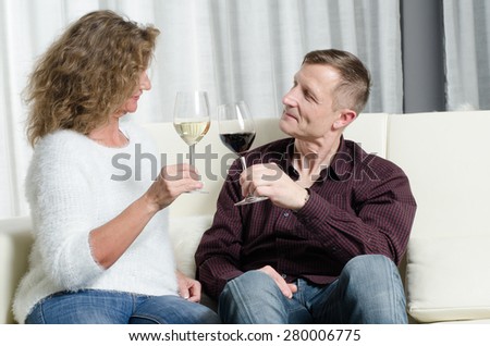 couple is wine tasting on couch