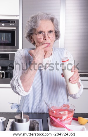 active female  senior in kitchen