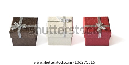 Three gift boxes with silver ribbon isolated on white