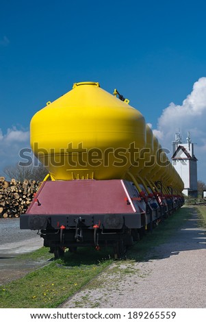 Freight trains with blue background, interesting contrast by yellow tanks with bright blue \