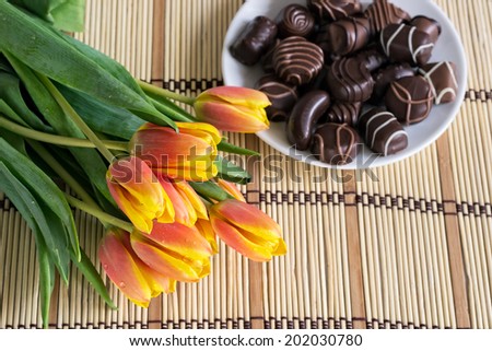 Bouquet of tulips and chocolate candies. Selective Focus.