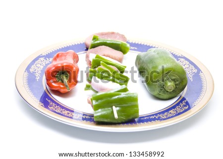 Meat spit with Vegetables on Plastic Plate