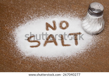 Salt written on counter in spilled salts from shaker