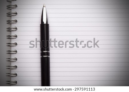 Blank notebook with black spiral bindings and a pencil.