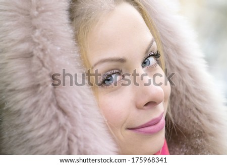 Beautiful image of a young woman in a fur coat, outdoor shot