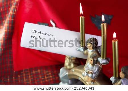 Christmas candles and letter with christmas wishes text to Santa, indoor shot with particular focus