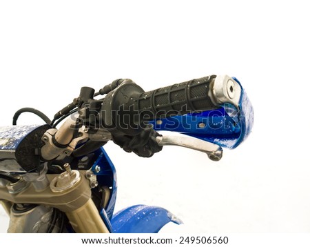 Close up of a motorcycle throttle control and handlebar in snow, outdoor shot with particular focus
