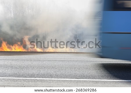 A bus escaping from fire,  outdoor shot with blur motion, concept of war or natural disaster