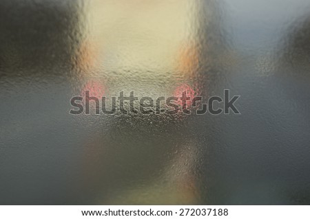 Splatter on a windscreen while truck overtaking in a rainy weather, de focused shot, concept of risk and danger