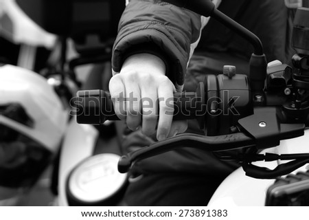 Hand of a child on a throttle control in black and white