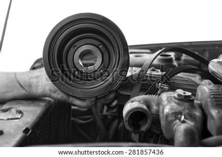 Hand of mechanic holding an engine pulley, isolated on white shot
