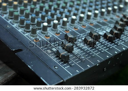 Angled shot of the old analogue mixing console, outdoor shot with a shallow depth of field
