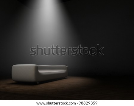 Couch in dark room with spotlight from top