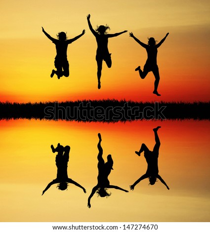Jumping people at sunset