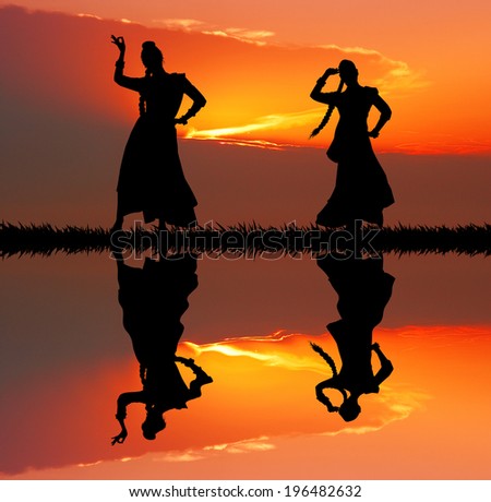 Women dancing indian dance at sunset