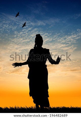 Woman dancing indian dance at sunset