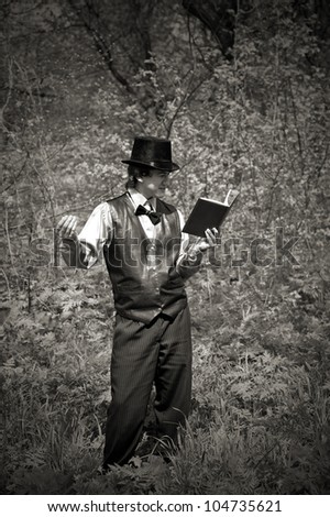 man reading book in old style dress. outdoor shot