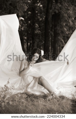 girl wrapped in white fabric. outdoor shot