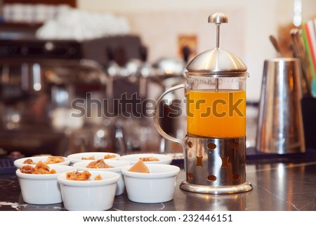 tea in a French-press with sweets