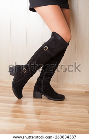 A boots with beautiful legs on wood