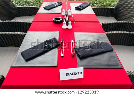 table setting with plates, napkin, silverware in a bright red color