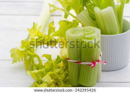 fresh celery sticks organic from natural at on white  wooden table